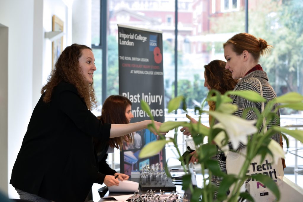 Dr Lucy Foss and Lt Emily Ashworth checking in delegates at the registration desk at the Blast Injury Conference 2018.