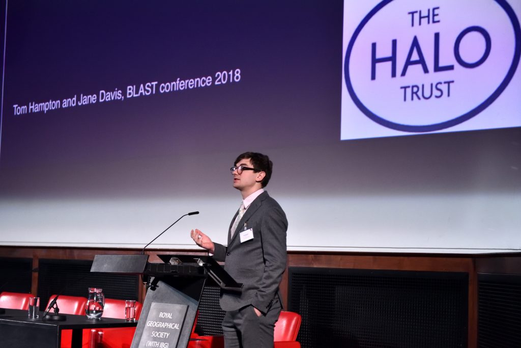 Tom Hampton from The Halo Trust presenting his talk on 'Injury trends from 20 years of landmine action in LMICs with the HALO Trust'.